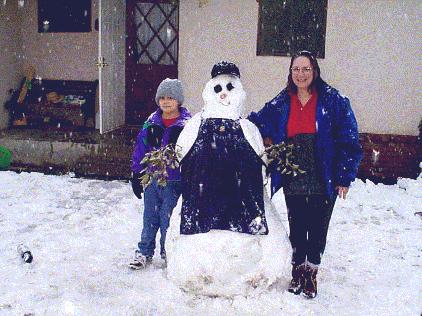 Daniel, Debbie and their snowman.